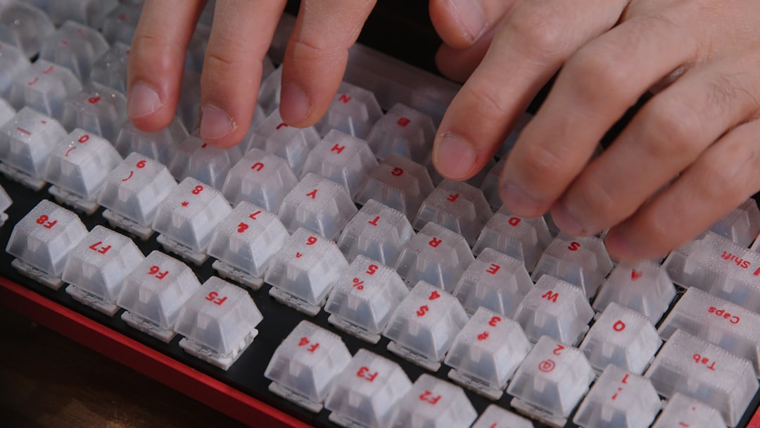 A close-up shot of a person typing on a keyboard, showcasing a 3D-printed mechanical keyboard.