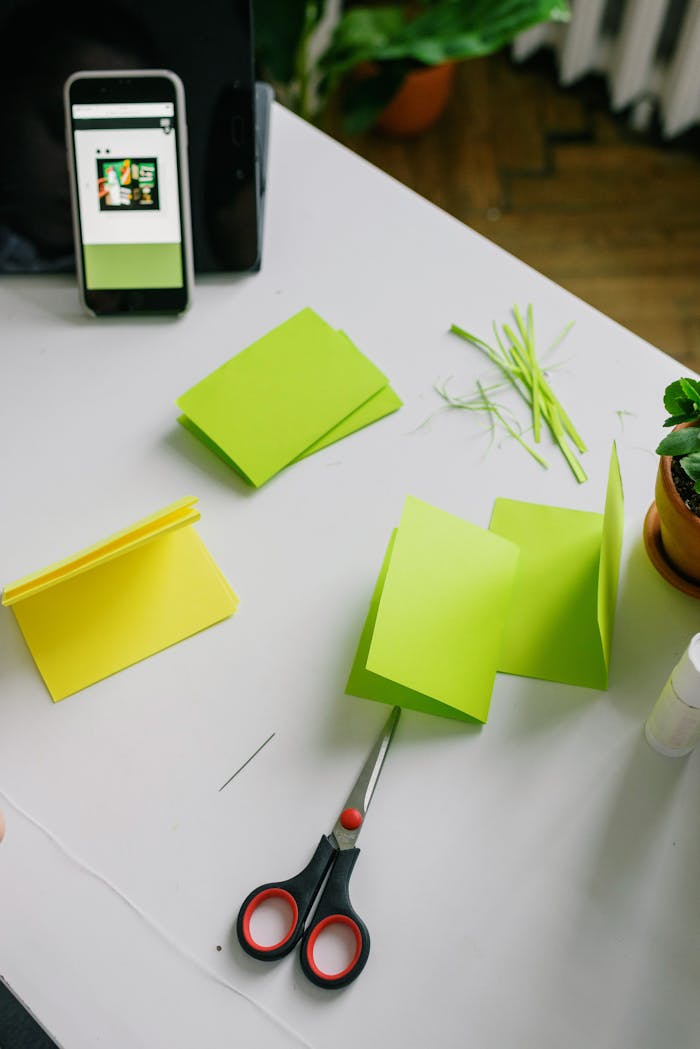 A creative crafting scene with colorful paper and scissors on a desk.